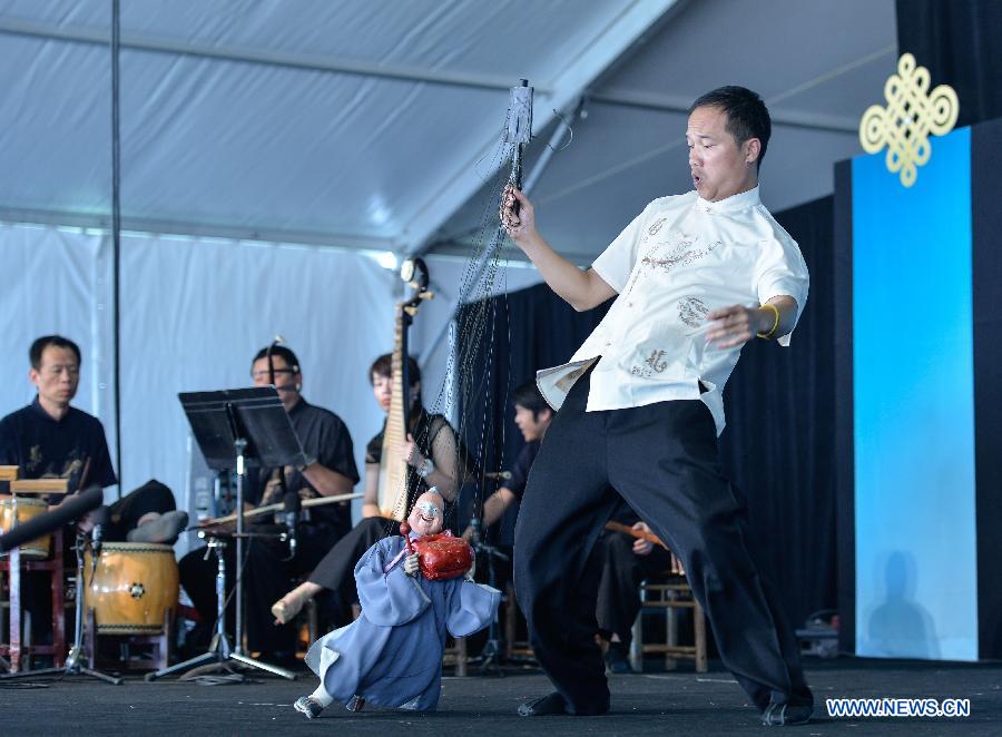 A performer plays the Quanzhou Puppet Troupe during the 48th Smithsonian Folklife Festival in Washington D.C., capital of the United States, July 6, 2014. The 48th annual Smithsonian Folklife Festival closed in Washington on Sunday. [Photo/Xinhua]