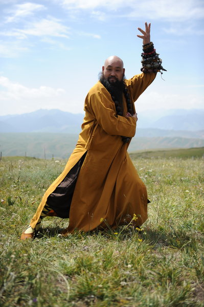 A master demonstrates Shaolin martial arts during the Tianshan Mountain Cultural Week, August 3, 2013. 